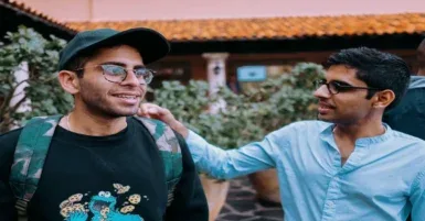 two men with one putting his hand on the others back